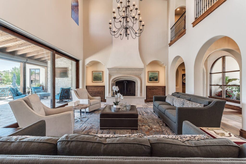 Elegant living room with high ceilings and a grand chandelier.